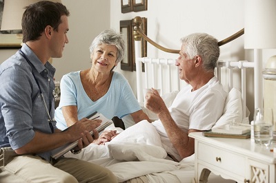 picture of a doctor visiting an elderly patient at his home