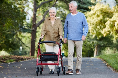 Picture of a Carer helping an elderly person working on a laptop