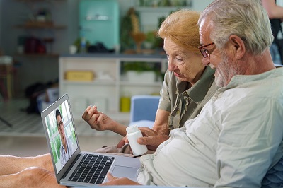 picture of elderly couple getting advice from doctor on a video call