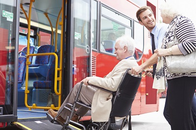 Picture of a Carer helping an elderly person working on a laptop